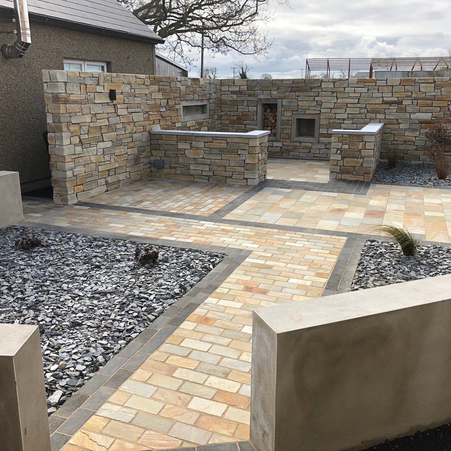 Patio area featuring a mix of natural stone paving products including Donegal Quartzite Cobbles in 200 x 100mm size. 