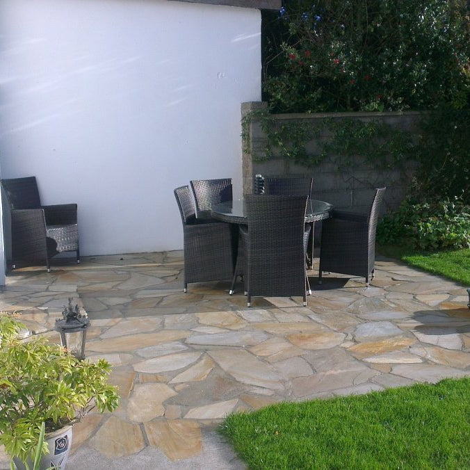 Small patio area with garden table and chairs on top of Donegal Quartzite Crazy Paving. 
