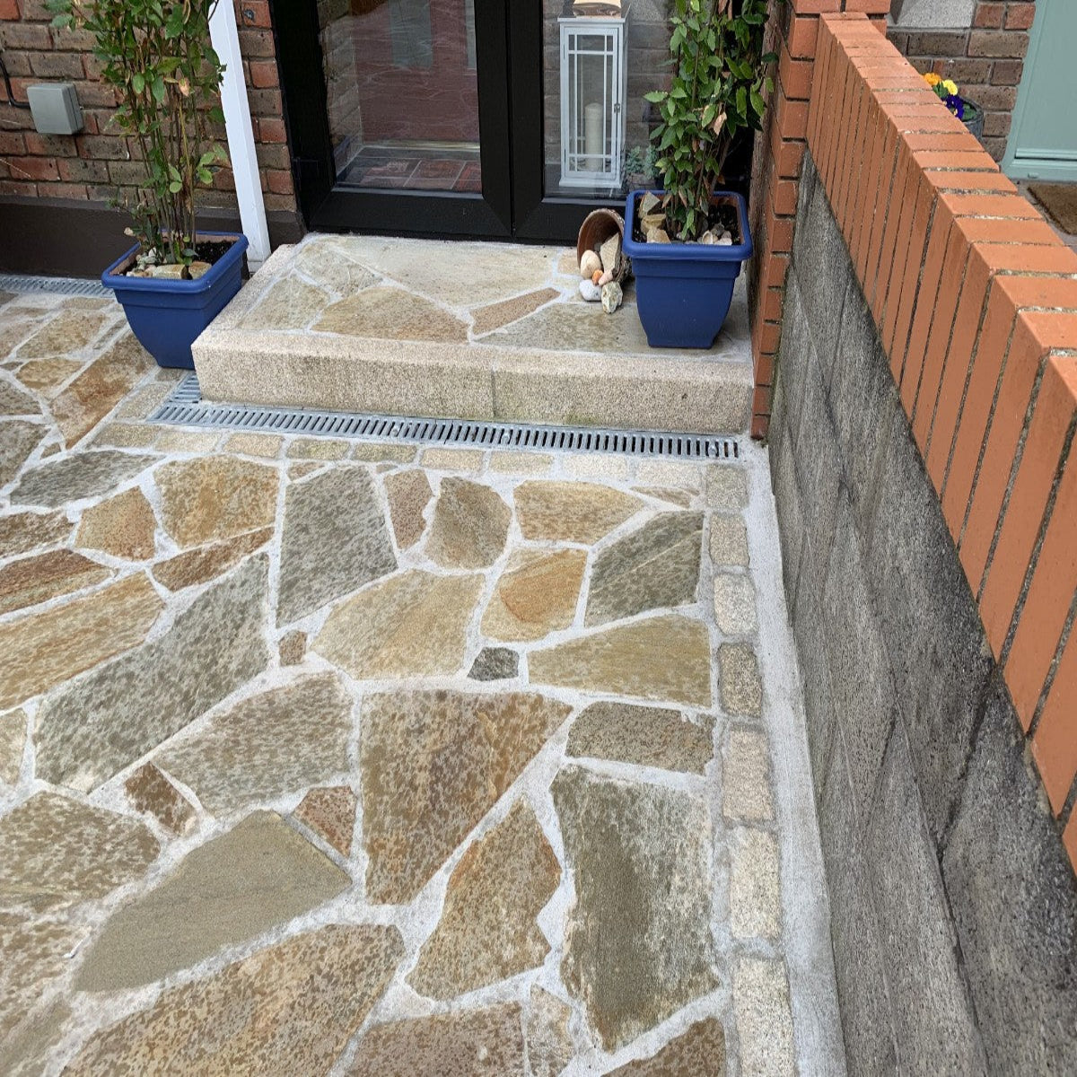 Donegal Quartzite Crazy Paving installed on a pathway and step leading to house entrance. 