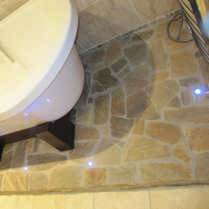 Donegal Quartzite Crazy Paving installed in a bathroom under a bath. 