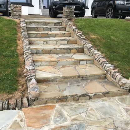 Steps completed using Donegal Quartzite Crazy Paving leading up towards parked cars and hotel entrance. 