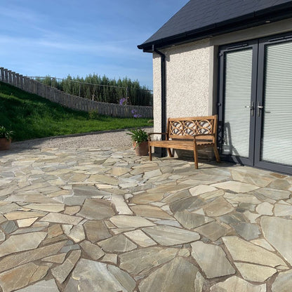 Patio area with brown bench. Paving is Donegal Quartzite Crazy Paving. 