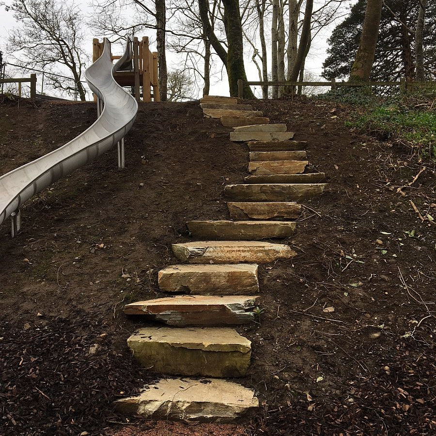Donegal Quartzite Garden Steps leading up to a playground slide with trees in the background