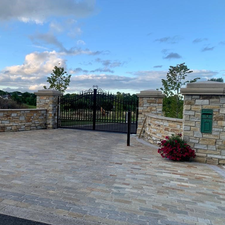 Paved driveway entrance with stone walls complete using Donegal Quartzite Paving Setts in Random Length x 100mm.