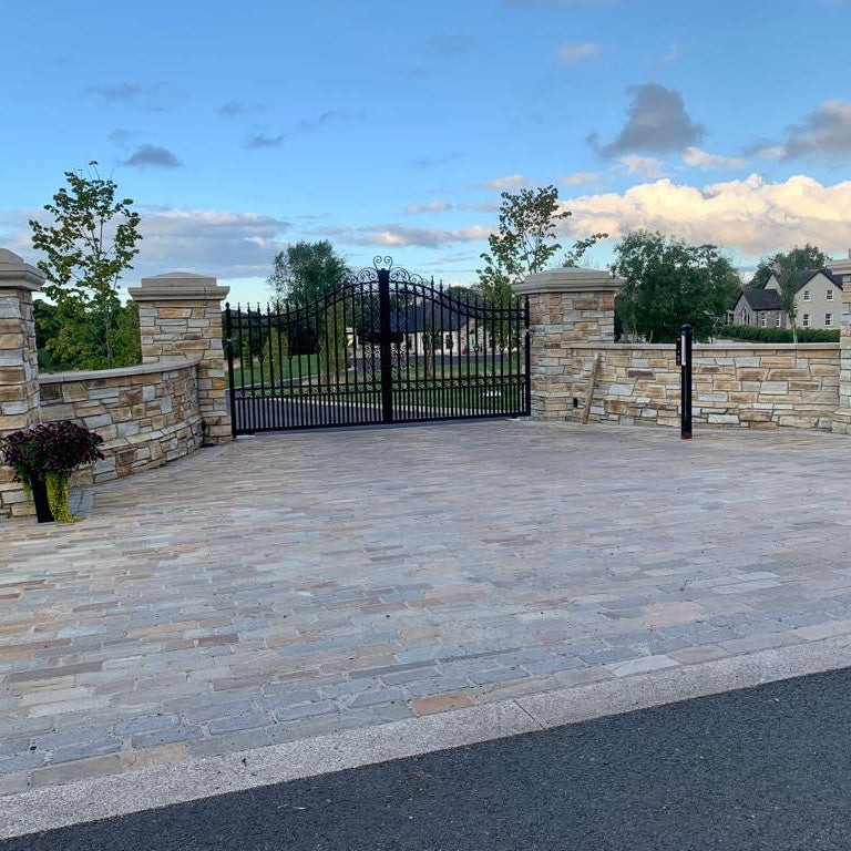 Paved driveway entrance with stone walls completed using Donegal Quartzite Paving Setts in Random Length x 100mm.