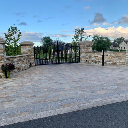 Paved driveway entrance with stone walls completed using Donegal Quartzite Paving Setts in Random Length x 100mm.