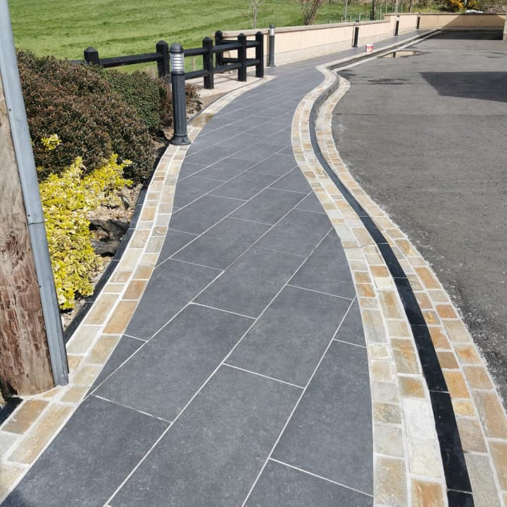 Pathway completed using Donegal Quartzite Paving Setts in Random Length x 100mm alongside natural stone paving and tarmac. 