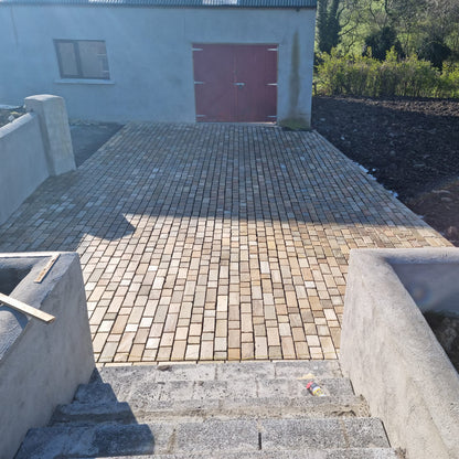 Patio area leading to shed paved with Donegal Quartzite Paving Setts in Random Length x 100mm.