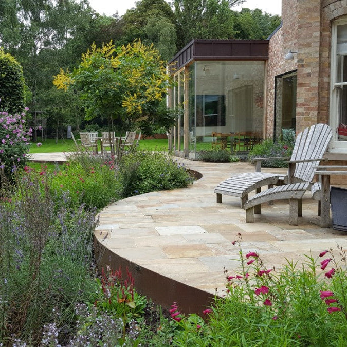 Contemporary home with beautiful patio area completed using Donegal Quartzite Sawn Paving.