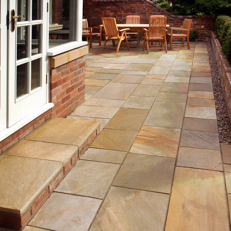 Patio area with step surrounded by red brick walling. Patio slabs are Donegal Quartzite Sawn Paving. 