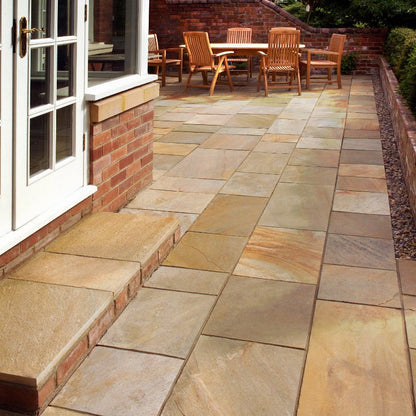 Patio area with step surrounded by red brick walling. Patio slabs are Donegal Quartzite Sawn Paving. 