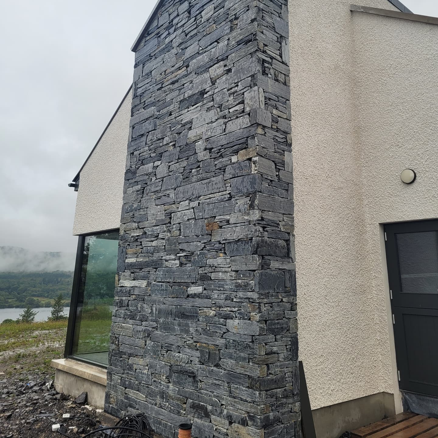 Stone facade of a building with a scenic background