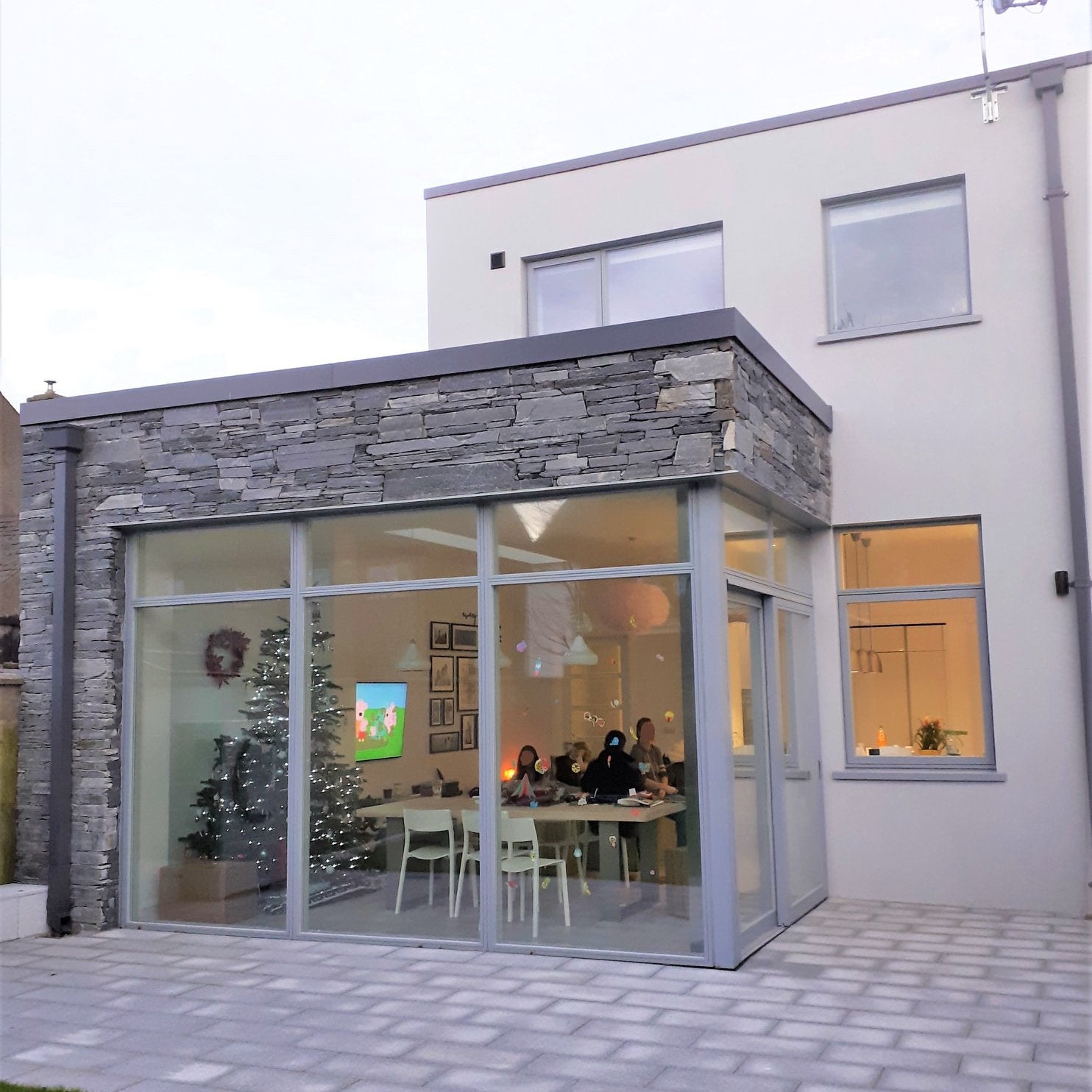Modern house with a glass extension featuring Donegal Slate Rubble Stonework. 