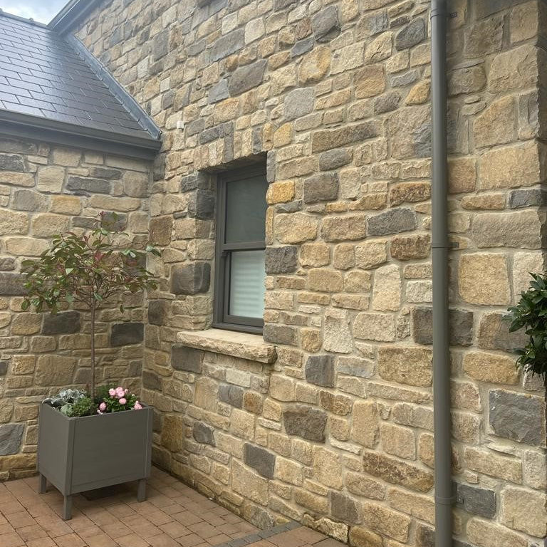 Close up of stone house completed using Dunhill Blend Sandstone Tumbled walling stone. 