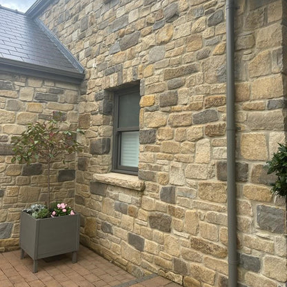 Close up of stone house completed using Dunhill Blend Sandstone Tumbled walling stone. 