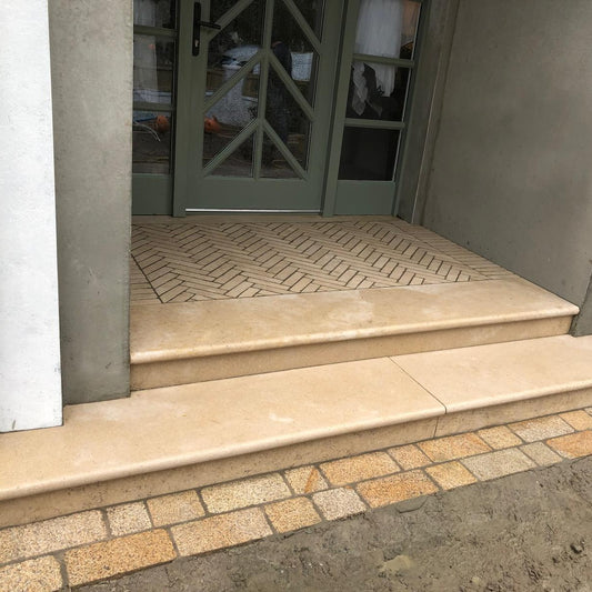 Egyptian Limestone Steps leading up to a door with a glass panel. 