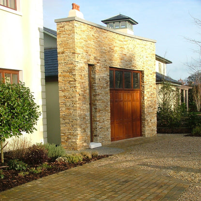 Donegal Quartzite cobbled driveway leading to a stone-built garage completed in Gold Donegal Quartzite Garden Walling.  