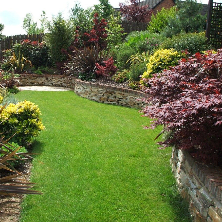 Garden with beautiful stone walls completed in Gold Donegal Quartzite Garden Walling in rugged form. 
