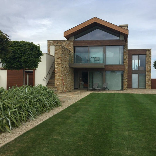 Modern house completed using Gold Donegal Quartzite Garden Walling. 
