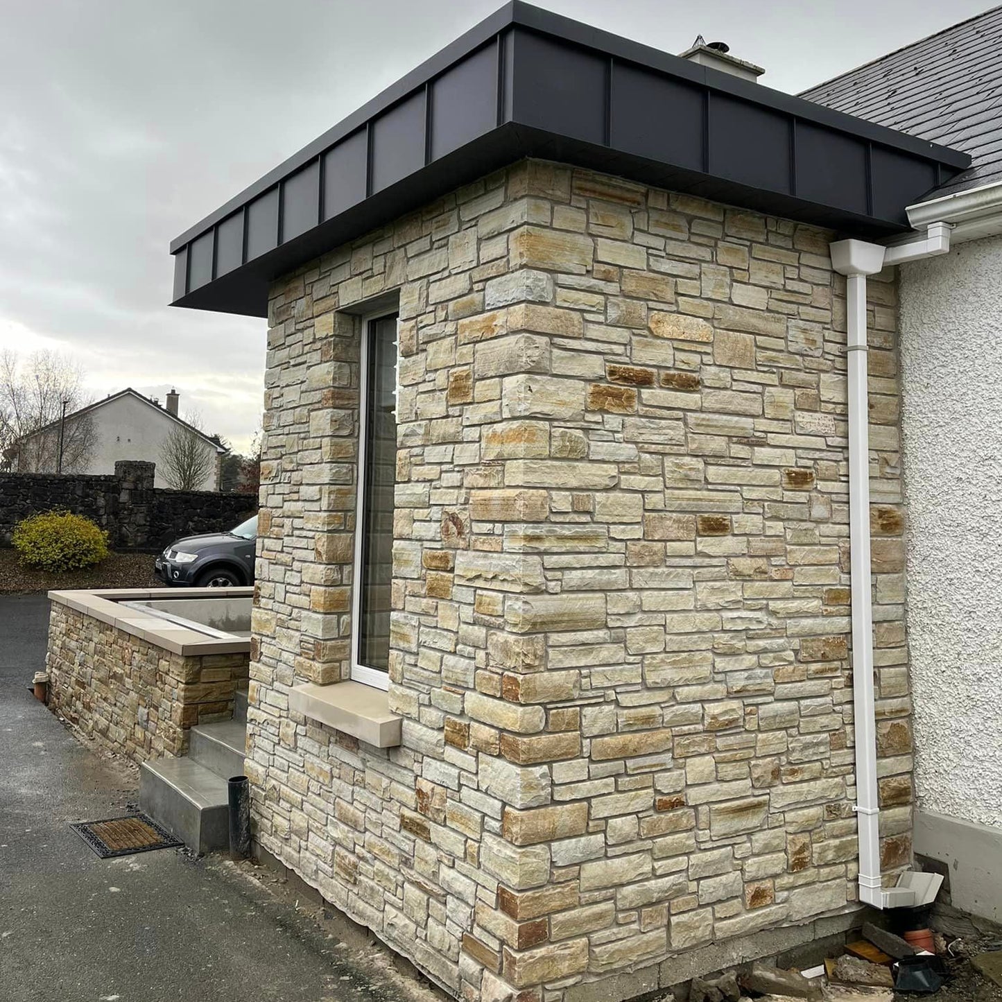 Porch extension and boundary wall completed using Gold Donegal Quartzite Machined walling stone. 