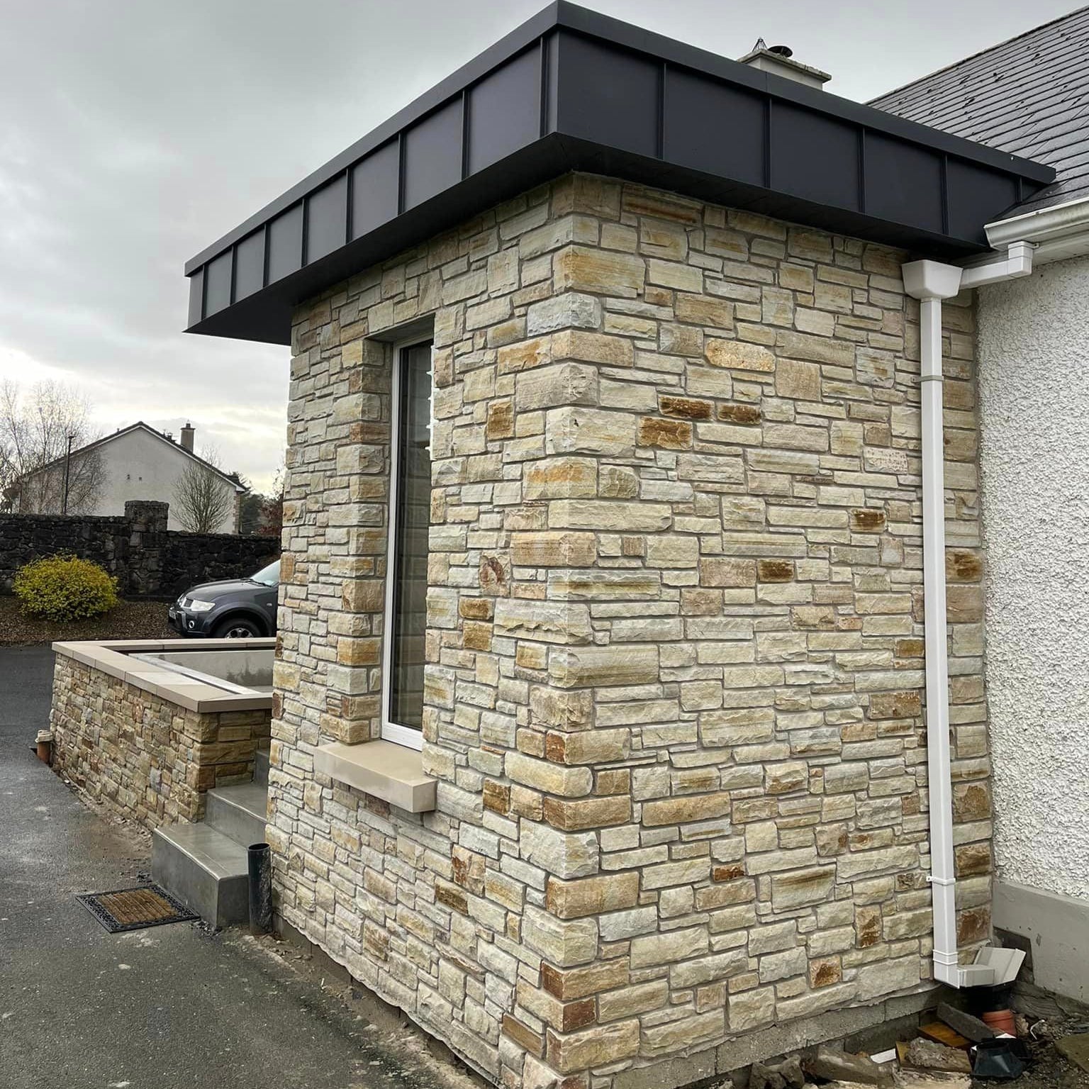 Porch extension and boundary wall completed using Gold Donegal Quartzite Machined walling stone. 