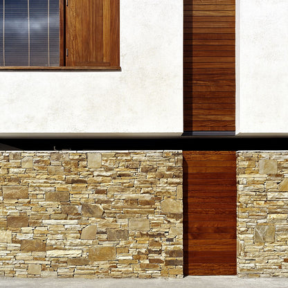 Close up of Gold Donegal Quartzite Random Rubble on a building façade with wood detailing. 