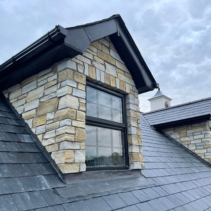 Dormer roof window decorated in Gold Donegal Quartzite Stoneer Cladding. 