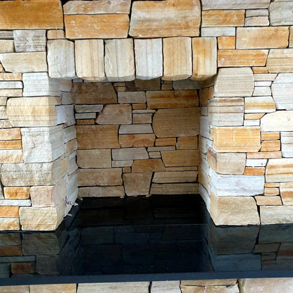 Fireplace completed using 30mm Gold Donegal Quartzite Stoneer Cladding with a black hearth.