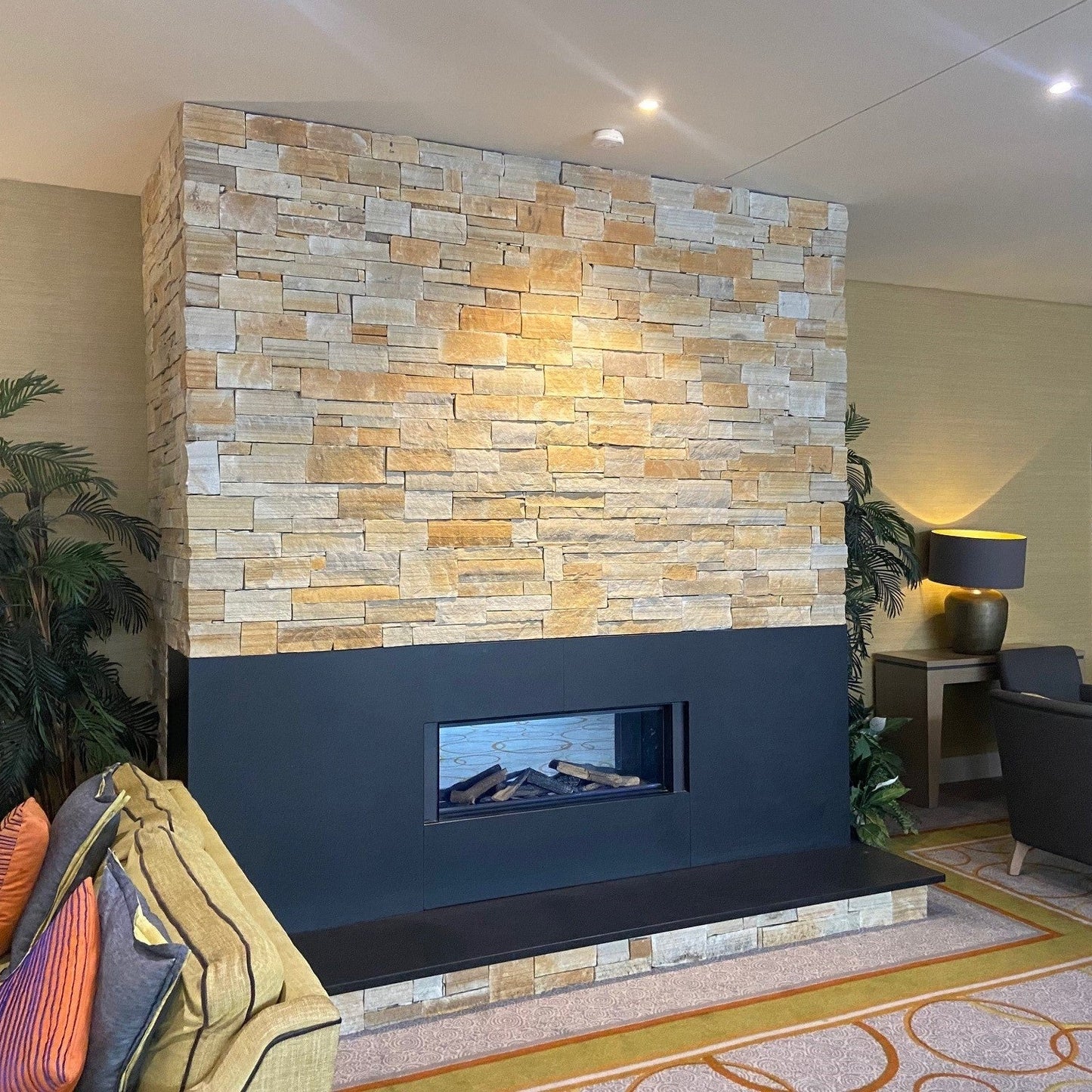 Natural stone fireplace in Gold Donegal Quartzite Stoneer Cladding.