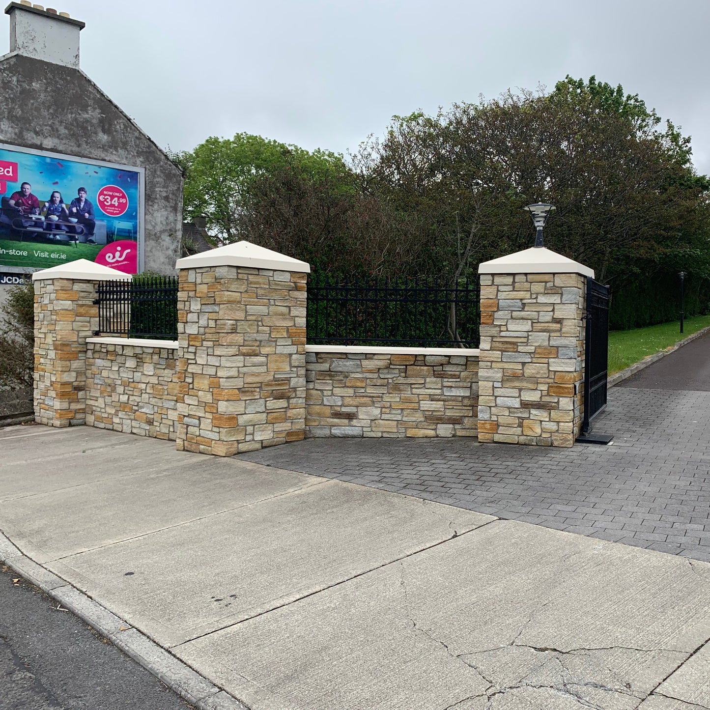 Entrance wall and pillars completed using 30mm Gold Donegal Quartzite Stoneer Cladding and bespoke Sandstone pillar caps.