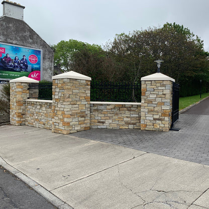 Entrance wall and pillars completed using 30mm Gold Donegal Quartzite Stoneer Cladding and bespoke Sandstone pillar caps.