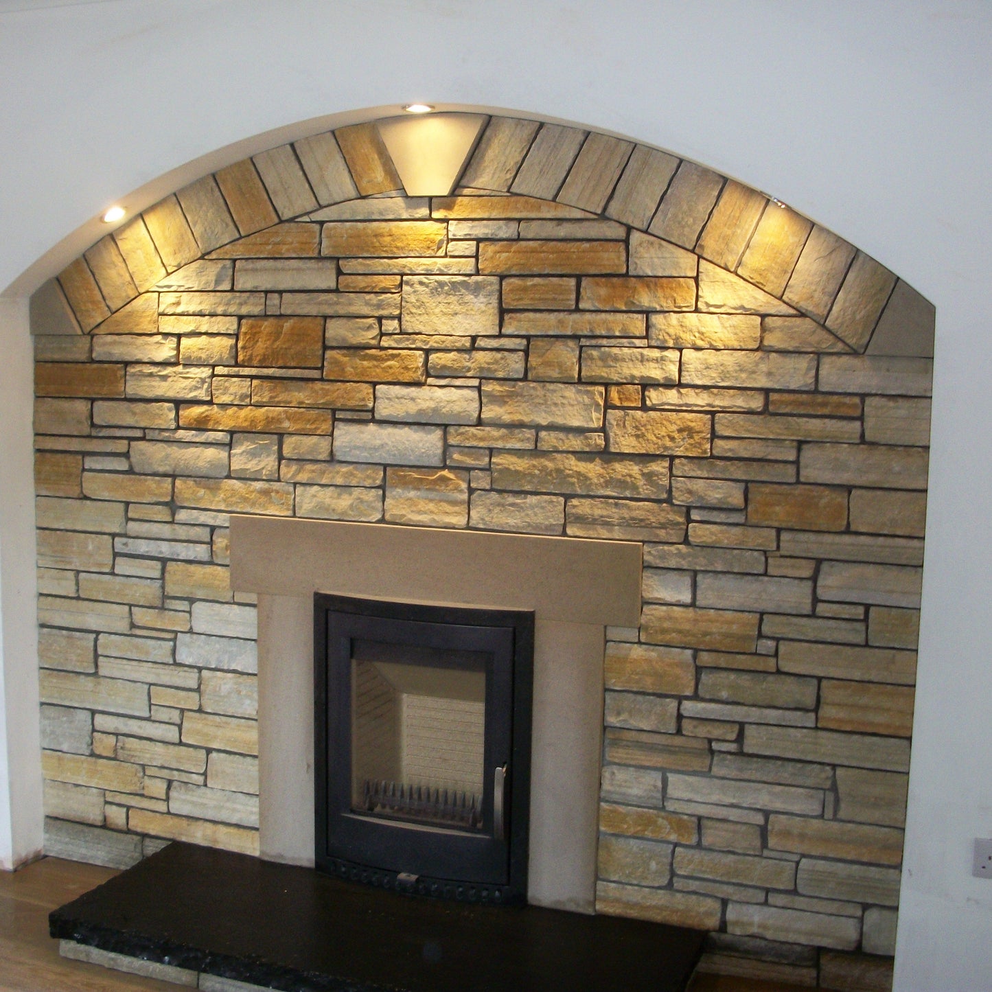 Stone fireplace finished in 30mm Gold Donegal Quartzite and Sandstone Surround. 