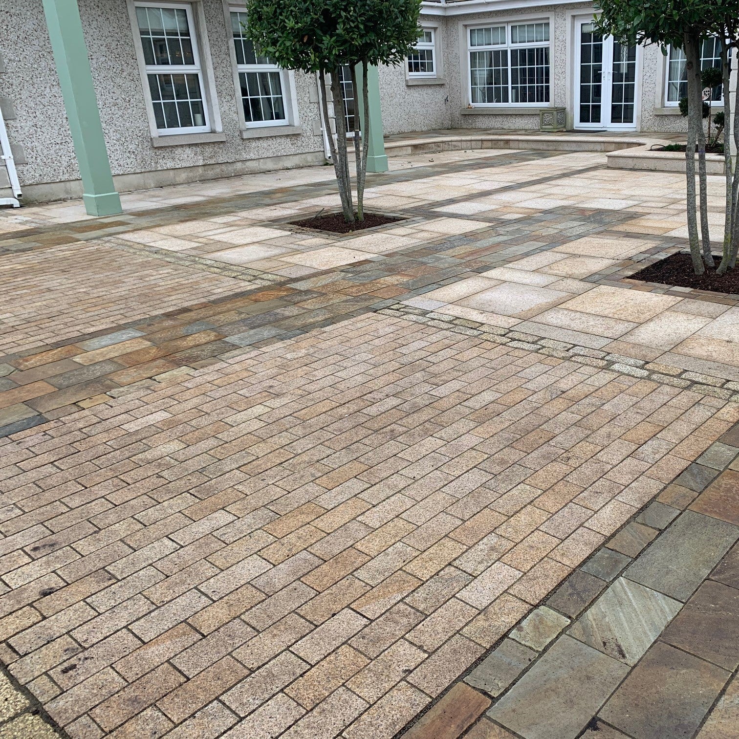 Paved patio area featuring Sawn Gold Granite Paving Cobbles in 200 x 100mm size. 