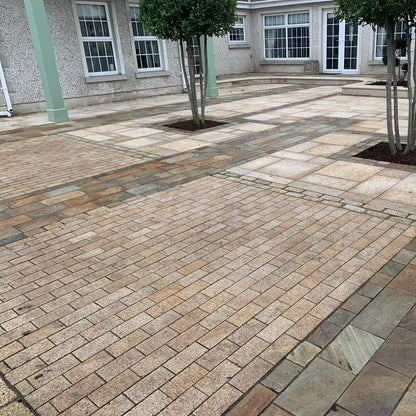 Paved patio area featuring Sawn Gold Granite Paving Cobbles in 200 x 100mm size. 