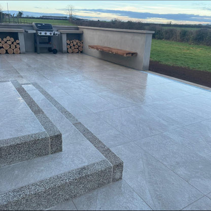 Porcelain patio and steps completed using Gold Granite Kerbing. 