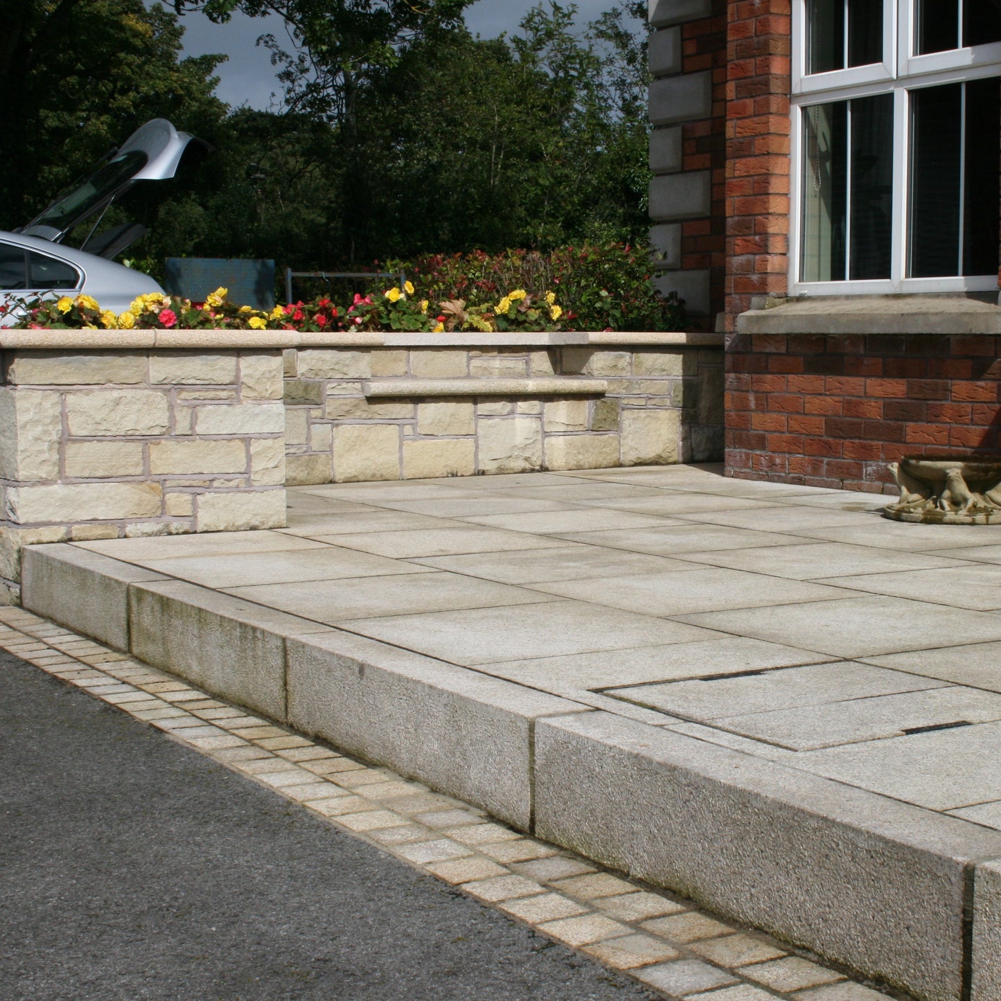 Red brick house with patio area completed using Gold Granite Kerbing. 