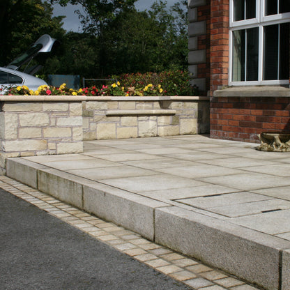 Red brick house with patio area completed using Gold Granite Kerbing. 