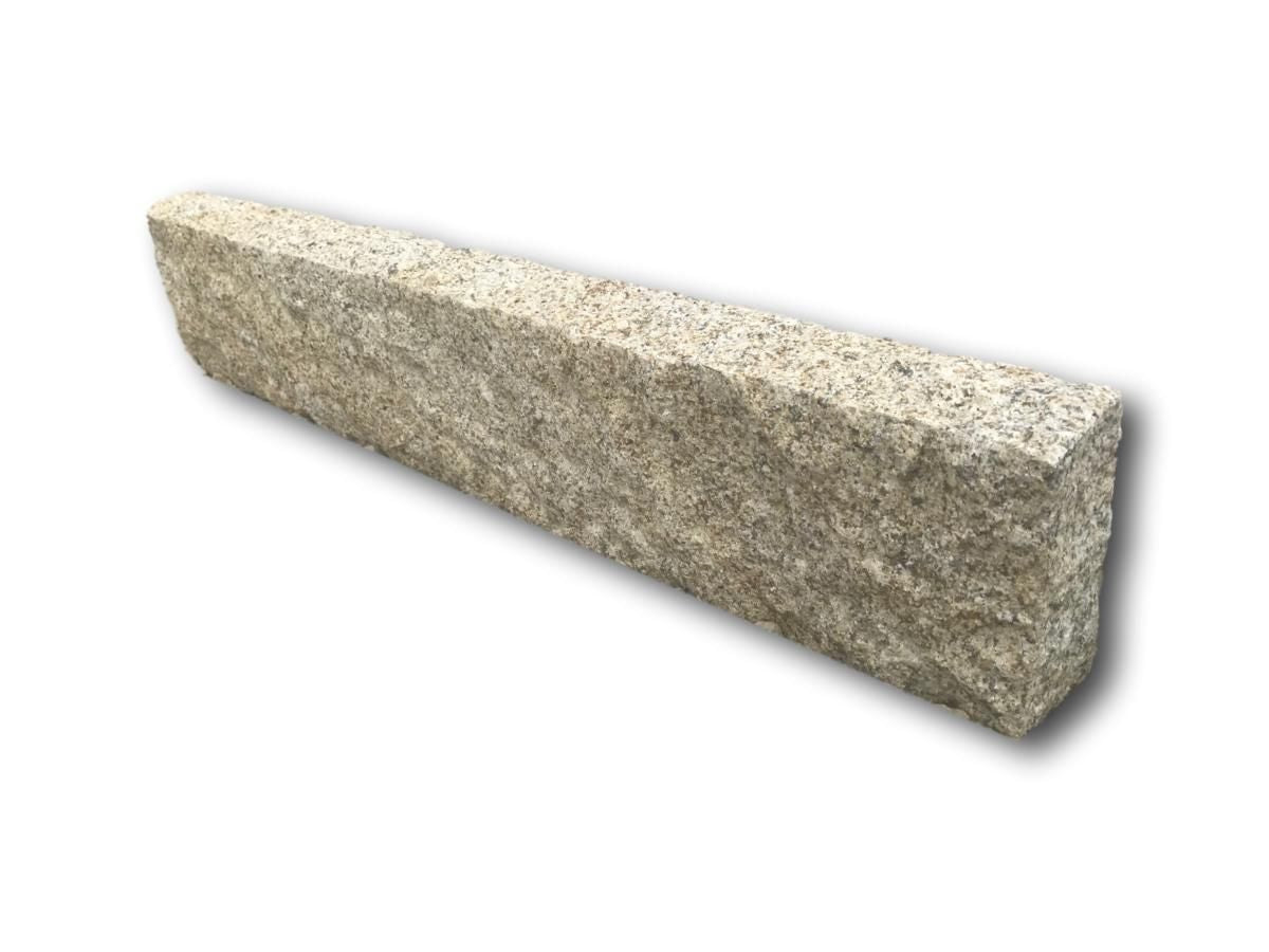 A single gold granite kerb with a pineapple finish on a white background. 