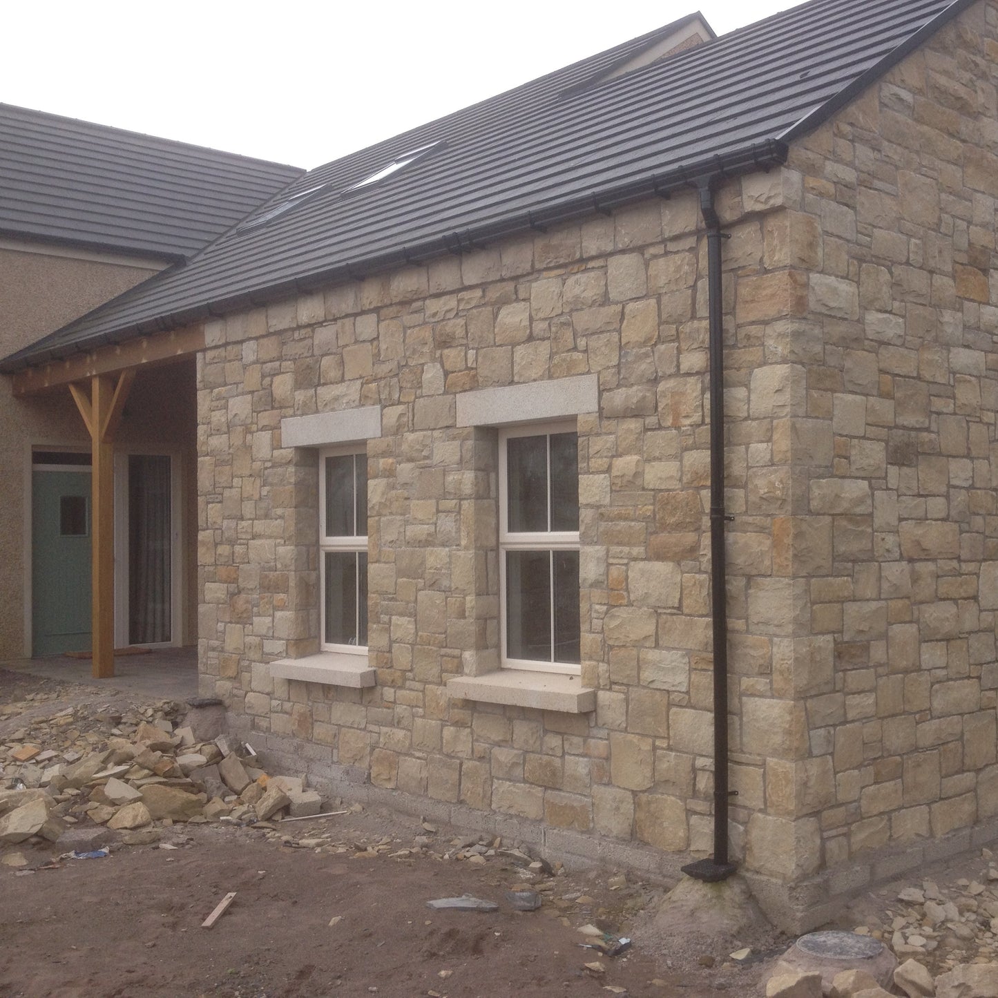 Stone building under construction with bespoke Gold Granite Window lintels and siils. 