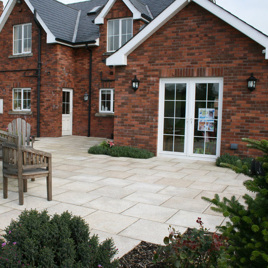 Red brick house with patio area completed using Gold Granite Paving in 600 x 600mm size. 