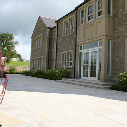 Large sandstone house with gold granite patio area and steps. Paving is 600 x 600mm size. 