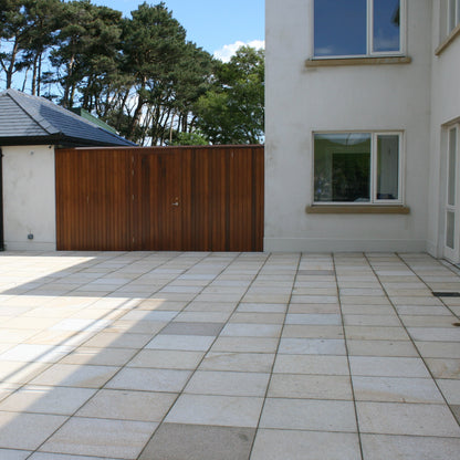Large patio area featuring Gold Granite Paving in 600 x 600mm size. 