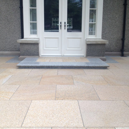 Patio doors leading out onto a Gold Granite Patio featuring paving slabs in 600 x 600mm size.