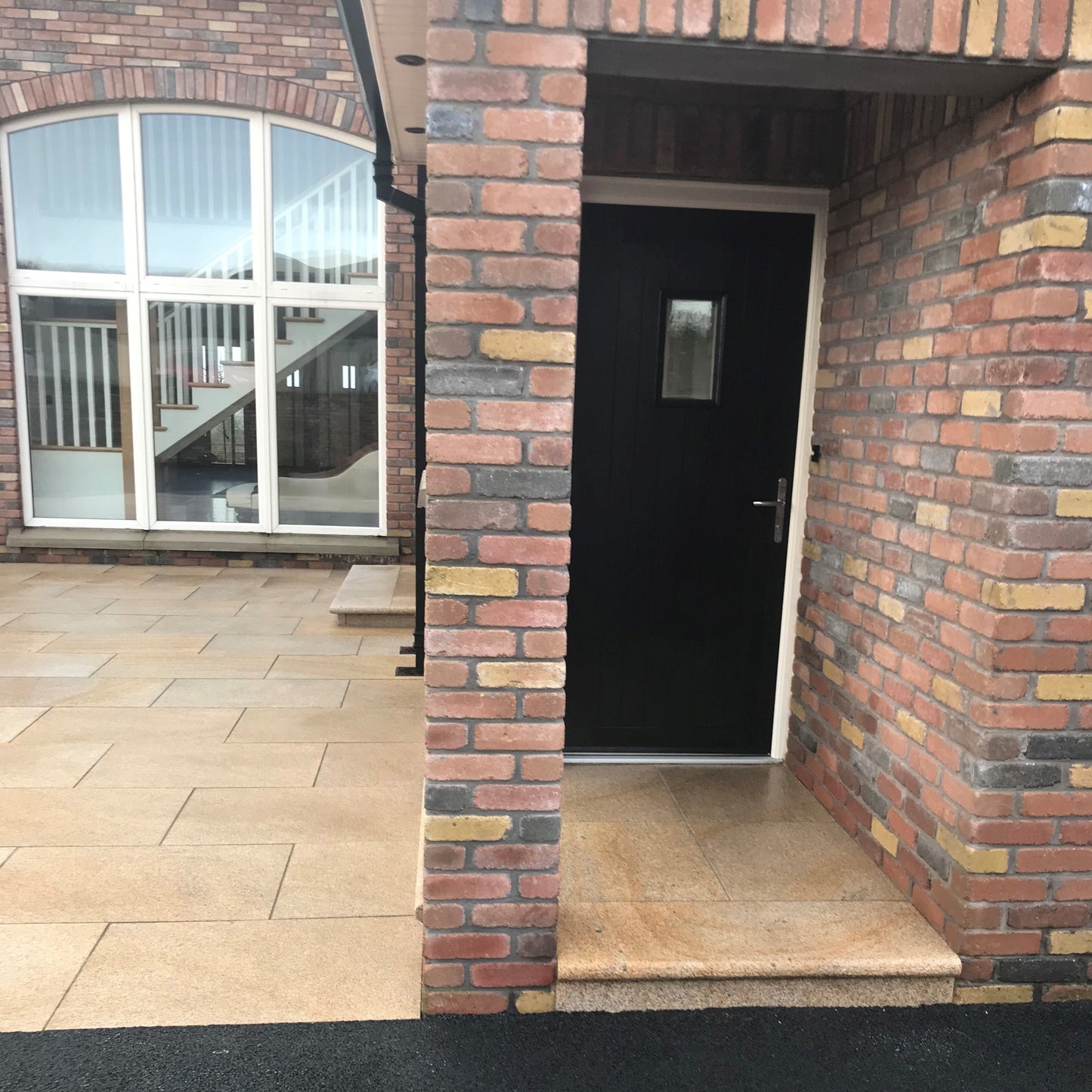 Back door step area leading to a large patio finished using Gold Granite Paving in 900 x 600mm 