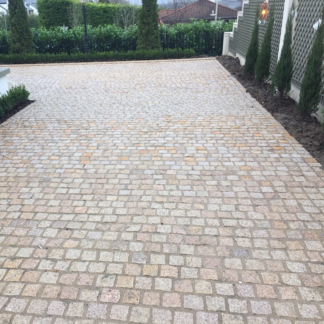 Patio area completed using lightly tumbled Gold Granite Paving Cobbles in 100 x 100mm. 
