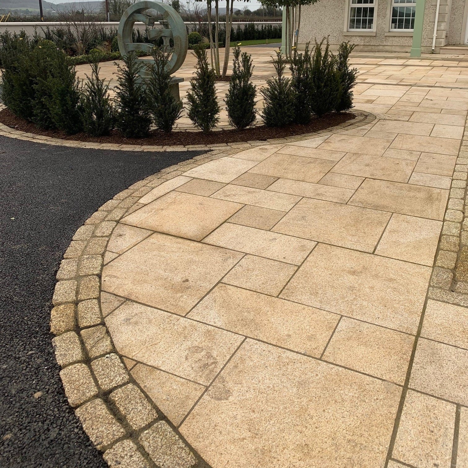 Gold Granite Patio with double row of Gold Granite Paving Cobbles in 200 x 100mm size. 