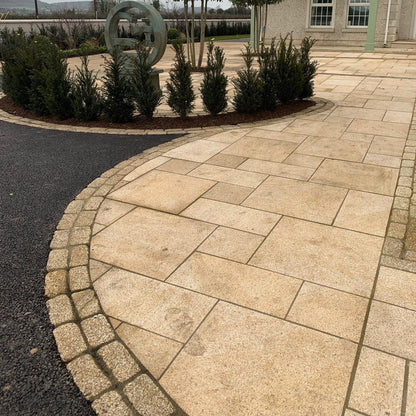 Gold Granite Patio with double row of Gold Granite Paving Cobbles in 200 x 100mm size. 