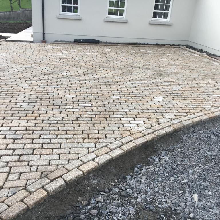 Patio area nearing completion using Gold Granite Cobbles with lightly tumbled finish. 