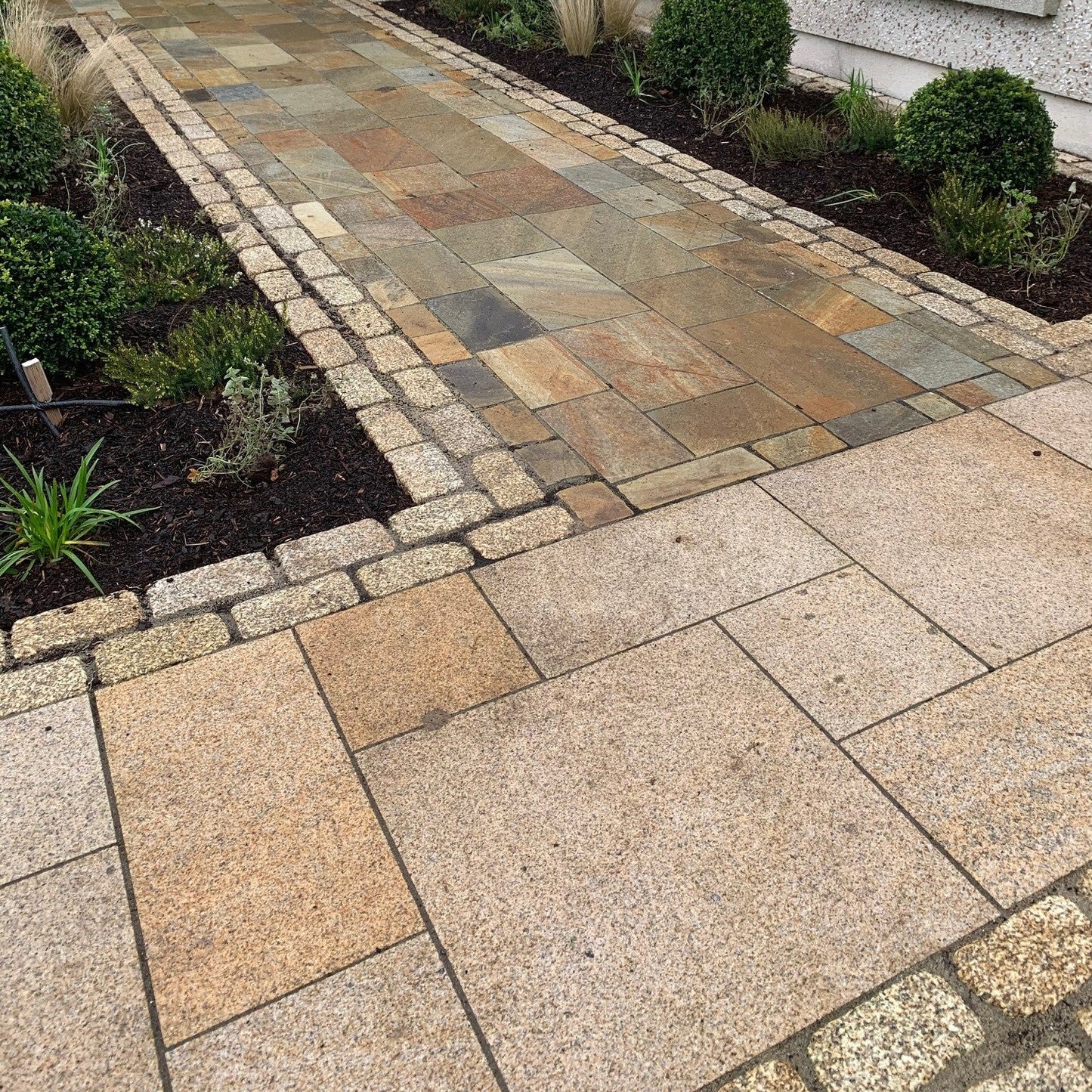 Pathway border completed using lightly tumbled Gold Granite Paving Cobbles in 200 x 100mm size. 