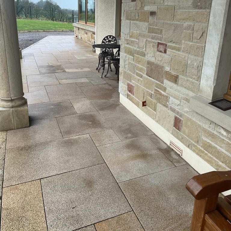 Small patio area completed using Bush Hammered Gold Granite Paving in mixed sizes.  